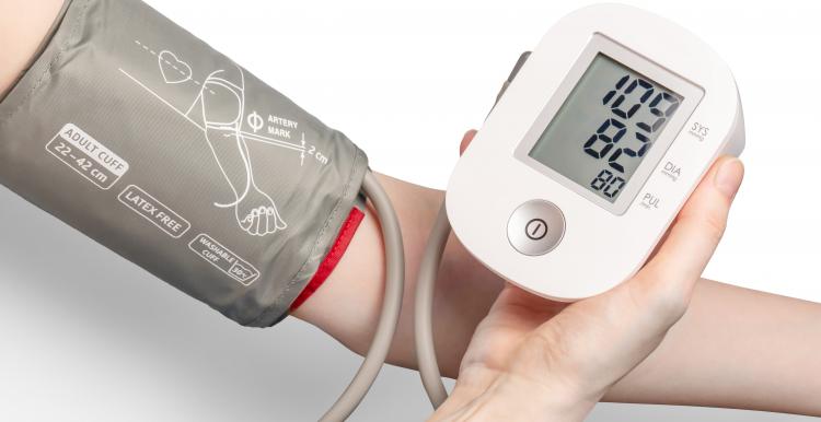 Close up of an arm with a blood pressure monitor