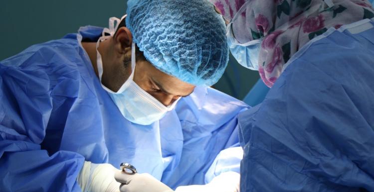 A surgeon and team performing an operation