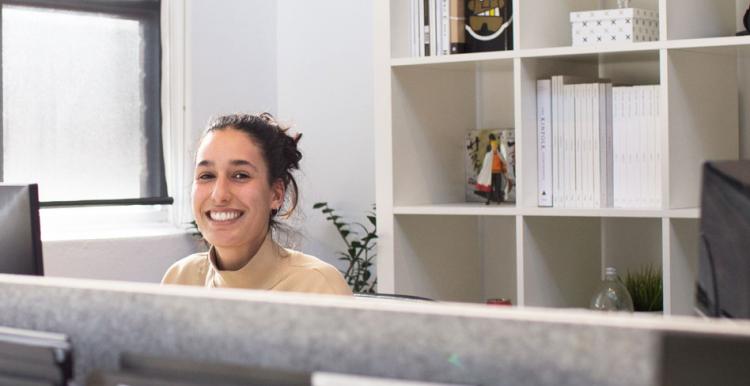  A smiling receptionist, sat behind her desk