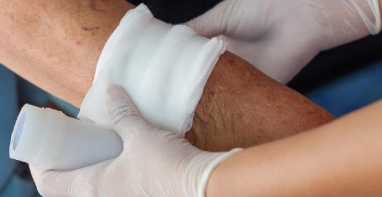 Image of bandage being applied to arm