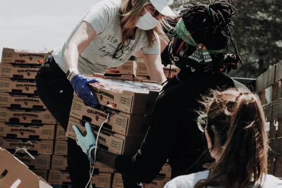 Volunteers offloading food parcels from the back of a truck
