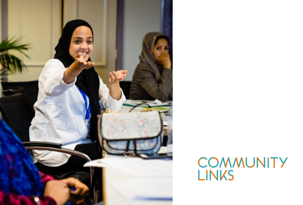 A young Muslim lady, in a meeting, smiling 