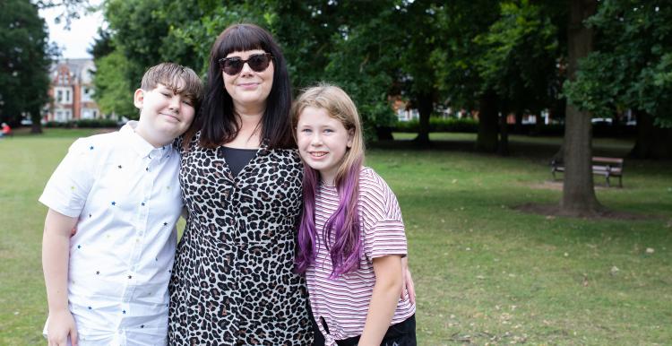 A mother with her son and daughter in a park