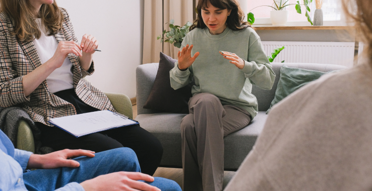 A photo of a group of people speaking with each other