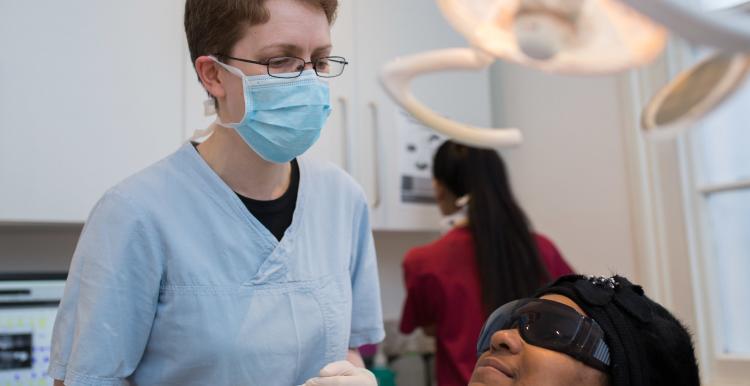 Dental surgeon with patient sitting in the chair