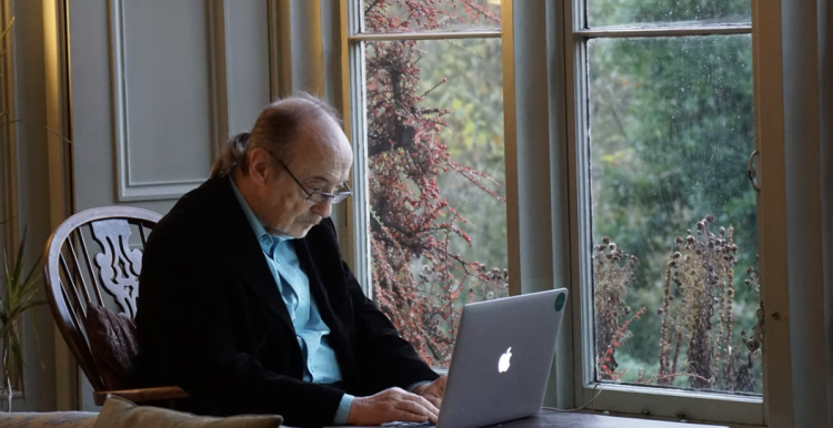 An elderly man using a laptop