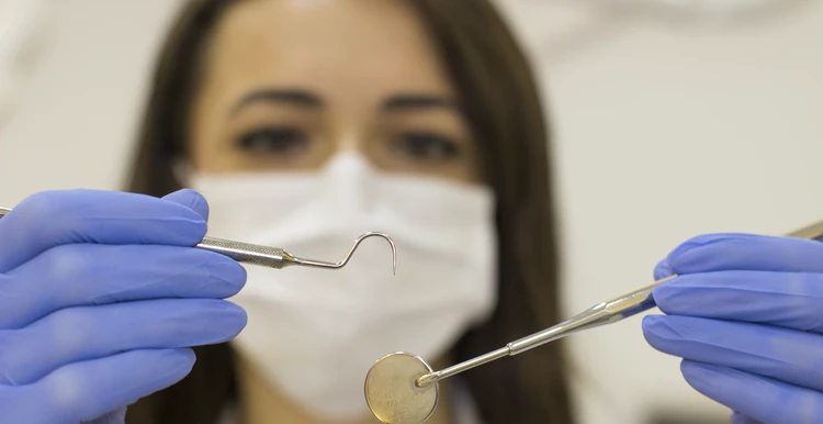 Dentist looking at equipment