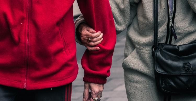 Close-up of carer walking with service user