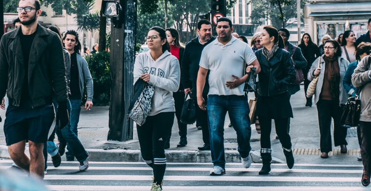 People walking in the street, unmasked