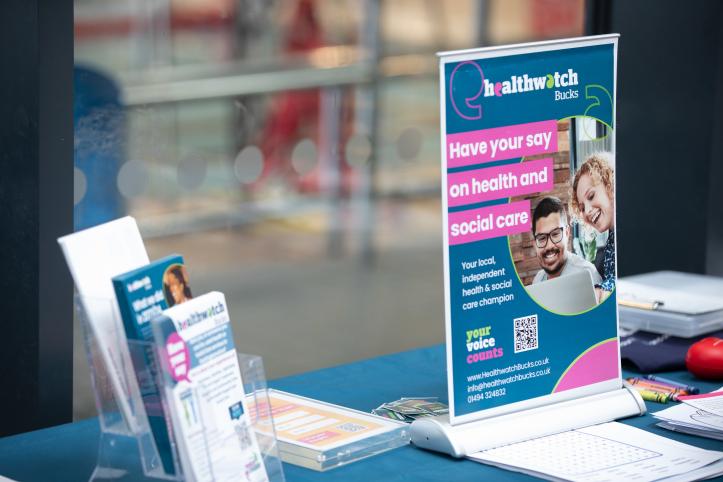 A photo of a healthwatch stall with a poster that reads 'have your say on health and social care'