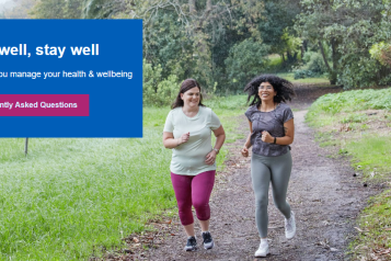 Two women jogging on path