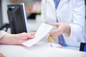 prescription being handed to pharmacist