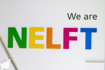 A photo of a sign that says 'we are NELFT'