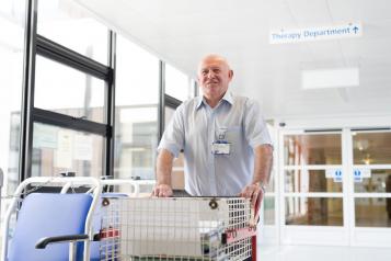 Hospital porter with a trolley