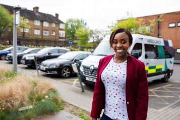 Woman stood in front of an ambulance