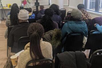 Group of people listening to speaker