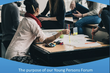 A group of young people sat around a table