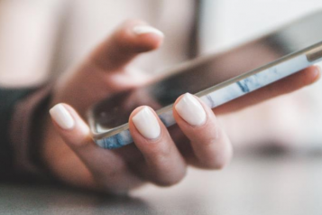 A woman looking at data on her mobile phone