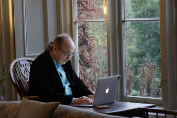 An elderly man using a laptop