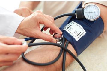A blood pressure monitor being used on s person's arm
