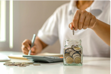 person saving coins in a jar