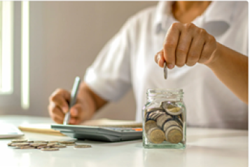 Image of hand dropping money into a jar