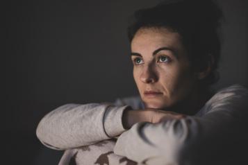 Lady looking ahead with head on arms