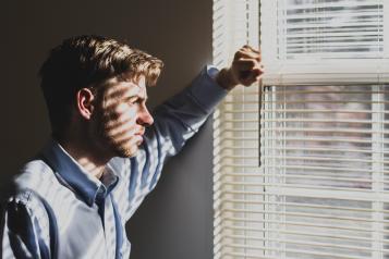 A young man looking out of a window