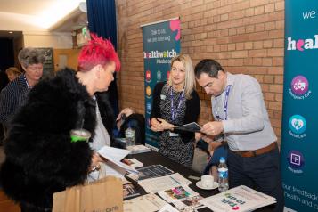 Woman speaking to member of public at community event