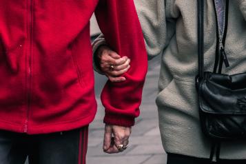 Close-up of carer walking with service user