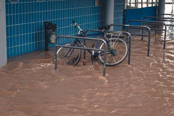 A chained up bike in flood water