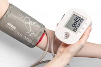 Close up of an arm with a blood pressure monitor