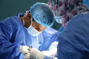 A surgeon and team performing an operation