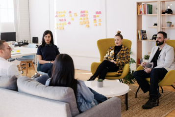 A group of people sat down at a meeting