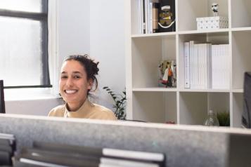  A smiling receptionist, sat behind her desk