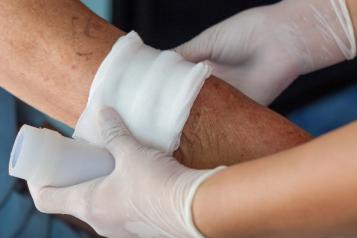 Image of bandage being applied to arm