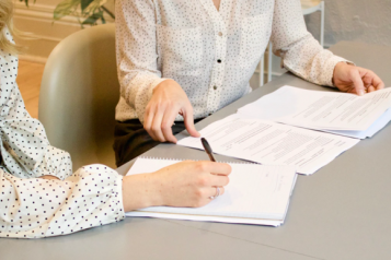 Close up to 2 women looking at a financial statement