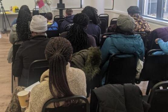 Group of people listening to speaker