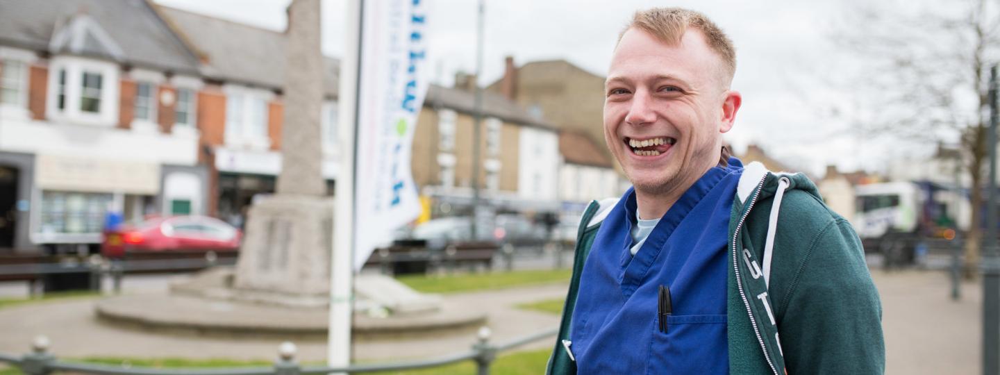 Man stood in front of a Healthwatch banner