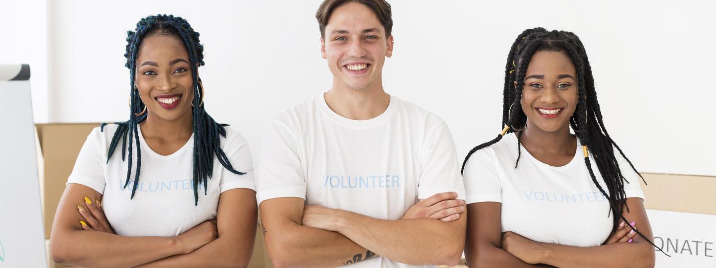 3 young volunteers smiling