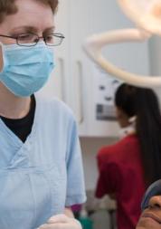 Dental surgeon with patient sitting in the chair