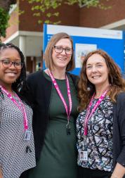 Three Healthwatch staff members standing outside a hospital