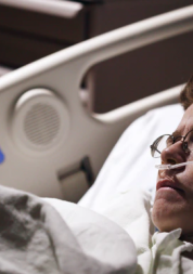 woman in hospital bed with tubes in her nose