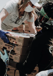 Volunteers offloading food parcels from the back of a truck