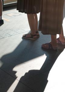 Peoples feet as they stand outside in a queue Peoples feet as they stand outside in a queue