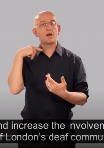 Screenshot from a video of a man doing sign language